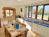 Breakfast time in Helena's kitchen with views to the freshly mown lawns