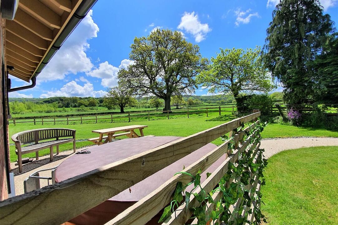 Outdoor hot tub at Woodside Retreat with countryside views at The Victorian Barn Dorset