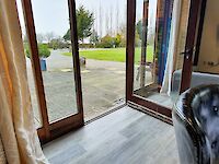 Spacious dining area with plenty of seating with doors to the patios