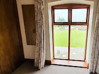 Ensuite king bedroom with views to the lawns and childrens' play area