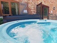 warm bubbling hot tub in front of Victoria Albert
