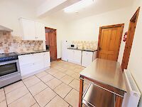 Large kitchen in Victoria Albert with range cooker, tiled floor and everything you need to cater for large groups