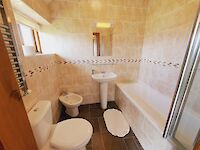 The king room with ensuite bathroom with bath and shower room