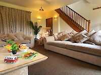 The lovely spacious lounge of Leopold with the feature wall in Sapphire Salute