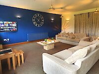 The lovely spacious lounge of Leopold with the feature wall in Sapphire Salute