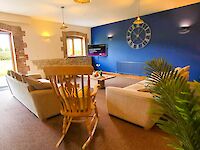The lovely spacious lounge of Leopold with the feature wall in Sapphire Salute
