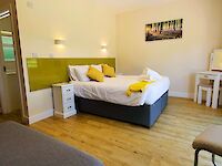 King or Twin ensuite bedroom with patio doors opening onto the patio with private hot tub and garden furniture