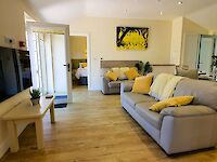 The lounge of Hollywood and fully fitted kitchen with doors opening onto the patio
