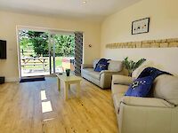 Welcoming lounge with throws and cushions and wonderful views to open countryside