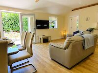 The spacious lounge of Maplewood with open plan kitchen and private patio