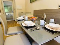 The spacious open plan kitchen and lounge of Maplewood