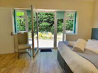 The view from the king or twin ensuite bedroom from the patio leading to the hot tub. This bathroom in Maplewood has a large walk in shower and also a full size bath