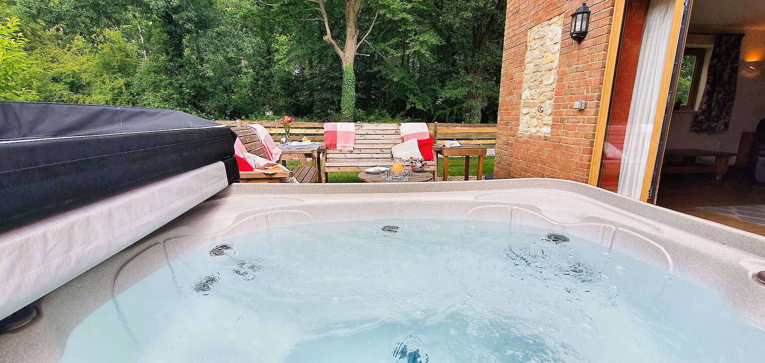 Private hot tub and enclosed garden at dog-friendly cottage in Dorset, perfect for relaxing countryside stays